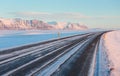 The road on a sunny winter day along the snow-capped mountains. Royalty Free Stock Photo