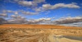 Road at sunset crossing the Karakum desert in Turkmenistan Royalty Free Stock Photo