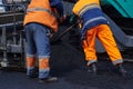 Road surface repair. Workers are laying asphalt on the road Royalty Free Stock Photo