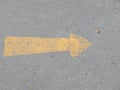 Road surface with yellow arrow sign, outdoor symbol, going forward, left to right, abstract photo