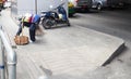 Road sweeper or Street cleaners ,woman carry broom cleaning the street in bangkok city Royalty Free Stock Photo