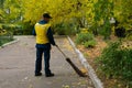 Road sweeper worker cleaning city street with broom tool Royalty Free Stock Photo