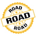 ROAD text on yellow-black round stamp sign