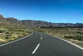 Road though scrubland leading to mountains Royalty Free Stock Photo
