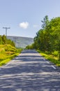 Road thru mountain forest landscape at sunny day Vang Norway Royalty Free Stock Photo