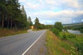 Road mountain landscape blue sky summer north nordic Norway trees forest green nature asphalt rural way country tree scenery trip Royalty Free Stock Photo