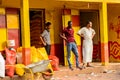 Unidentified local three men stand near the stock in a village