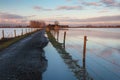 Road to a Dutch farm flooded by water Royalty Free Stock Photo