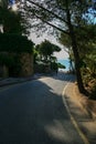 Lonely tarmac road to entrance of villa by the seaside and way t Royalty Free Stock Photo
