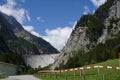 Road to huge grey wall of Gigerwald Dam.
