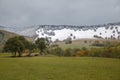 Lake Saint Ana, Transylvania, Romania - October 02, 2013: Heavy snowfall over night on the colorful autumn landscape of Royalty Free Stock Photo