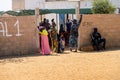 Unidentified Senegalese people stand near the entrance to the m