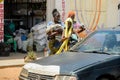 Unidentified Senegalese women in traditional clothes wait for a