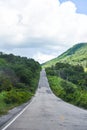 Road to mountain - A long straight road leading towards a nature green tree on the mountains , Asphalt road in Thailand Royalty Free Stock Photo