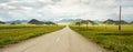 Road to the mountains through the valley on a summer day Royalty Free Stock Photo