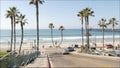 Road to ocean beach California USA. Summertime palm trees. Summer coast near Los Angeles. Sea waves.