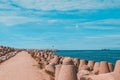 Road to a pier with a lighthouse, along the edges of the breakwater in Ventspils, Latvia