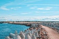 Road to a pier with a lighthouse, along the edges of the breakwater in Ventspils, Latvia