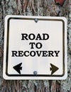 Road to recovery sign on a wooden board. Royalty Free Stock Photo