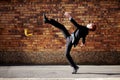 The road to success is a slippery one at best. A young businessman slipping on a banana peel.