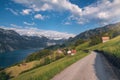 Road to Swiss village near a lake and the Alps Royalty Free Stock Photo