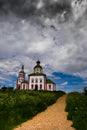 Road to the templeWhite church with blue domes under a stormy s Royalty Free Stock Photo