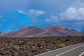 Road to Timanfaya with a storm in the background, over the volcanoes Royalty Free Stock Photo