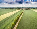 The road to the village through fields and meadows, abstract aerial view with dramatic clouds Royalty Free Stock Photo