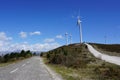 Road to windmills in wind park Royalty Free Stock Photo