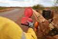 Road traffic authorize person wearing safety glove holding red warning flashing light Royalty Free Stock Photo