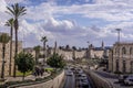 The road traffic on Jerusalem highway going along the walls of the Old town, with the palm trees, in Israel.