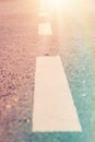 Road with Traffic Marking Stripes from Low Angle Perspective in Golden Sunlight Flare. Life Way Choice Destiny Harmony Challenge Royalty Free Stock Photo