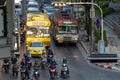 Road traffic with motorbikes and buses stopped on the red light