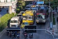 Road traffic with motorbikes and buses stopped on the red light