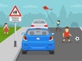 Happy kids playing near city road. Slow down, children playing ahead warning sign. Royalty Free Stock Photo