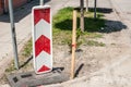 Road traffic sign work ahead with red and white barriers on the street construction site in the city Royalty Free Stock Photo