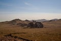 Road, trail in steppe with stone rocks among hills and mountains covered with green grass. Baikal nature. Mountain Royalty Free Stock Photo