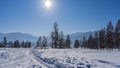 The road is trampled in a snow-covered valley. Royalty Free Stock Photo