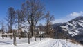 A road trampled in the snow runs along the slope of the mountain. Royalty Free Stock Photo