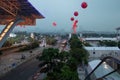 Road with transport, footpaths, palm trees, white tents. Modern big city. Red gel balls in the air. Royalty Free Stock Photo