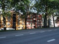 Road and trees in front of colorful houses in european Trondheim city at Trondelag district in Norway Royalty Free Stock Photo