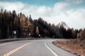 Road trip of car driving on highway with rocky mountains and pine forest in autumn at Banff national park Royalty Free Stock Photo