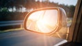 Road trip car mirror. Sun, highway car road reflection in mirror. Summer holidays trip concept. Royalty Free Stock Photo