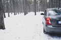 Road Trip Concept. Car on a winter road in the forest Royalty Free Stock Photo