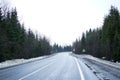 Road trip concept. Empty country road in winter, roadside in the snow. Winter trip Royalty Free Stock Photo
