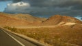 Road trip, driving auto from Death Valley to Las Vegas, Nevada USA. Hitchhiking traveling in America. Highway journey Royalty Free Stock Photo