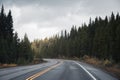 Road trip on highway road with sunlight on pine forest in overcast at Banff national park