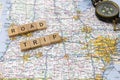 Road trip travel America map scrabble letters compass message