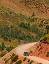 Road trip in the mountains solitary suv on dirt road Royalty Free Stock Photo