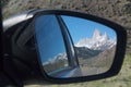 Road trip in patagonia, view in back mirror shows andes mountains Royalty Free Stock Photo